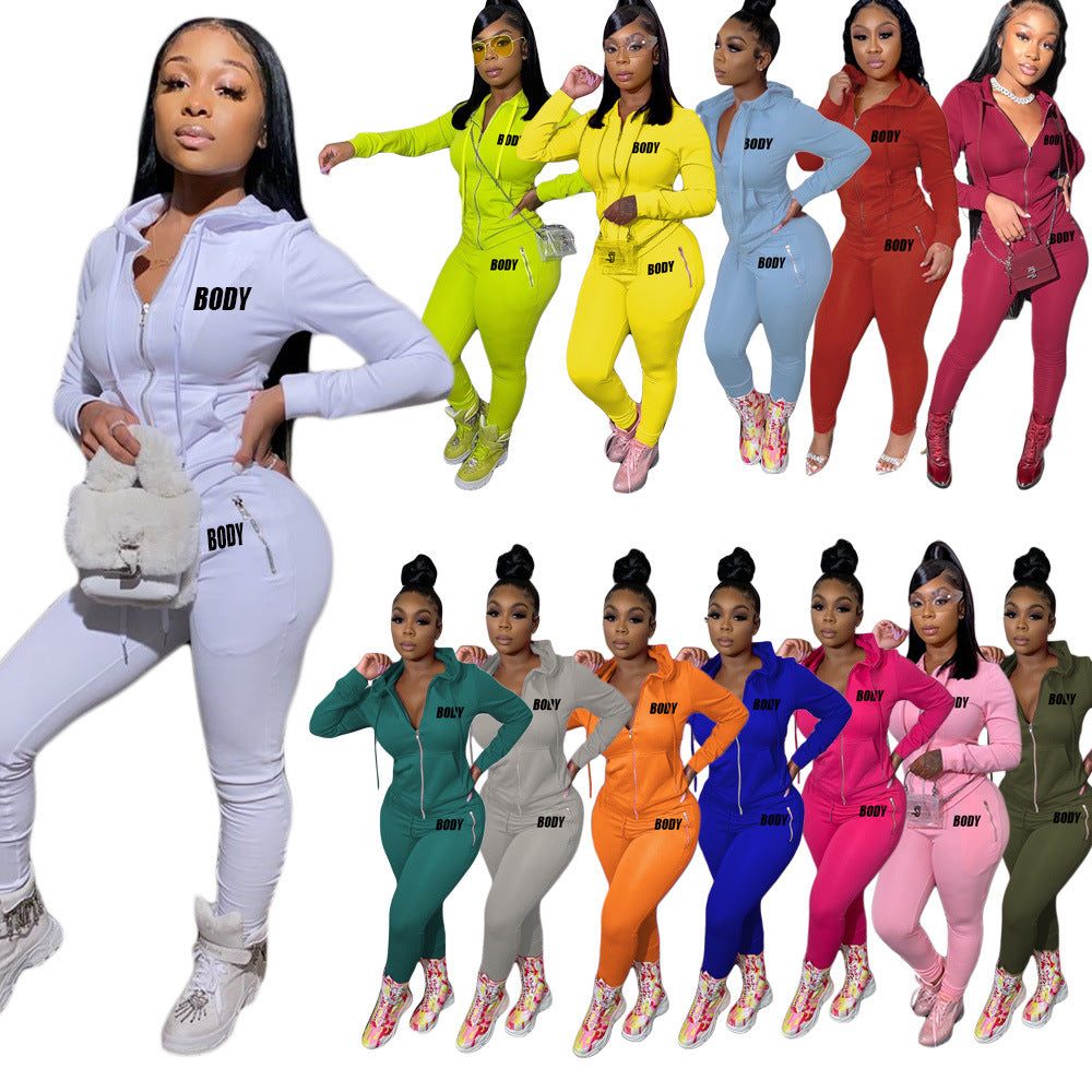 Women wearing slim-fit, zippered hooded tracksuits featuring "BODY" letter prints in various solid colors.