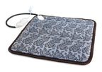 Grey pet heating pad with a floral pattern, brown trim, chew-resistant cord, and white power controller.
