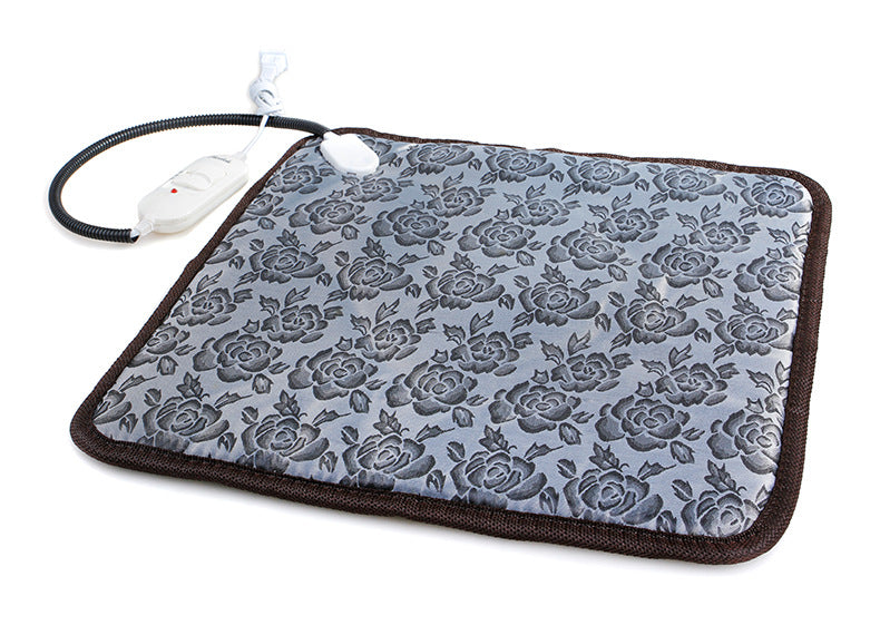 Grey pet heating pad with a floral pattern, brown trim, chew-resistant cord, and white power controller.