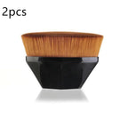 Set of two flat-top makeup brushes with soft brown synthetic bristles and ergonomic black diamond-shaped handles.