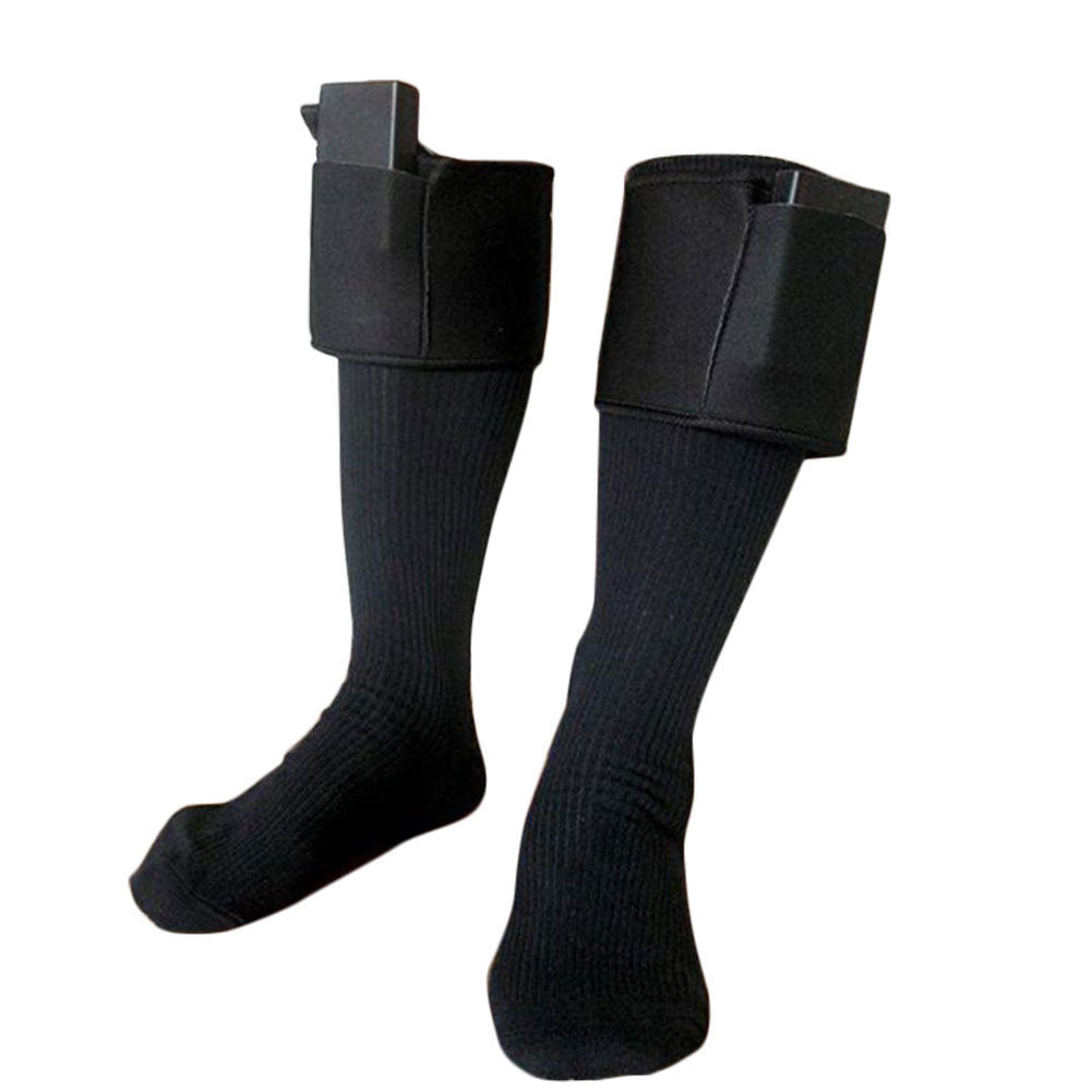 Pair of black knit electric heated socks with attached rectangular battery packs at the top cuffs. Isolated on white.