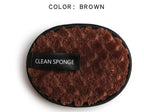 Oval brown textured microfiber makeup cleansing sponge with a black trim and "CLEAN SPONGE" label on a white background.