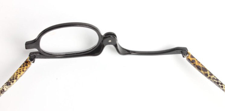Digitaldistribution375 black flip-lens makeup reading glasses with tan and black snakeskin-patterned arms.