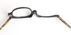 Digitaldistribution375 black flip-lens makeup reading glasses with tan and black snakeskin-patterned arms.