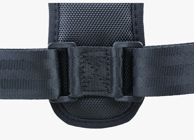 Black textile posture corrector strap with adjustable plastic buckles and padded mesh center panel on white background.