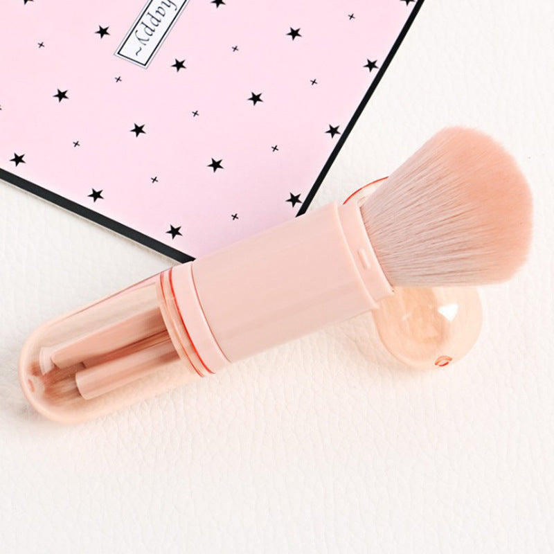 Pink portable 4-in-1 retractable makeup brush set with soft bristles and a protective clear cover.