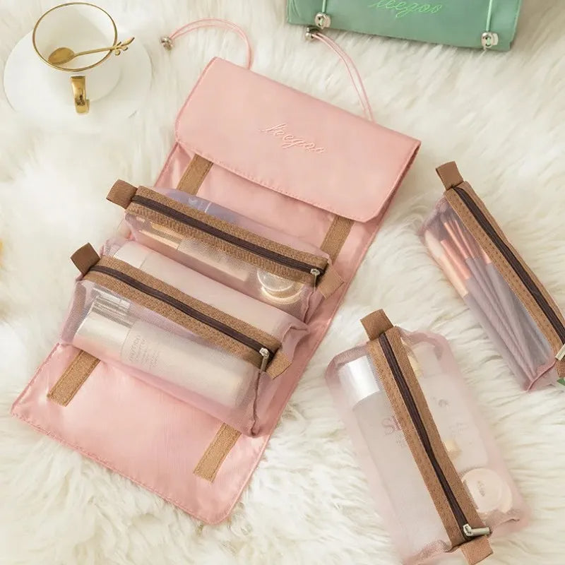 Pink 4-in-1 travel storage organizer with detachable mesh bags for toiletries and makeup on a white fur background.