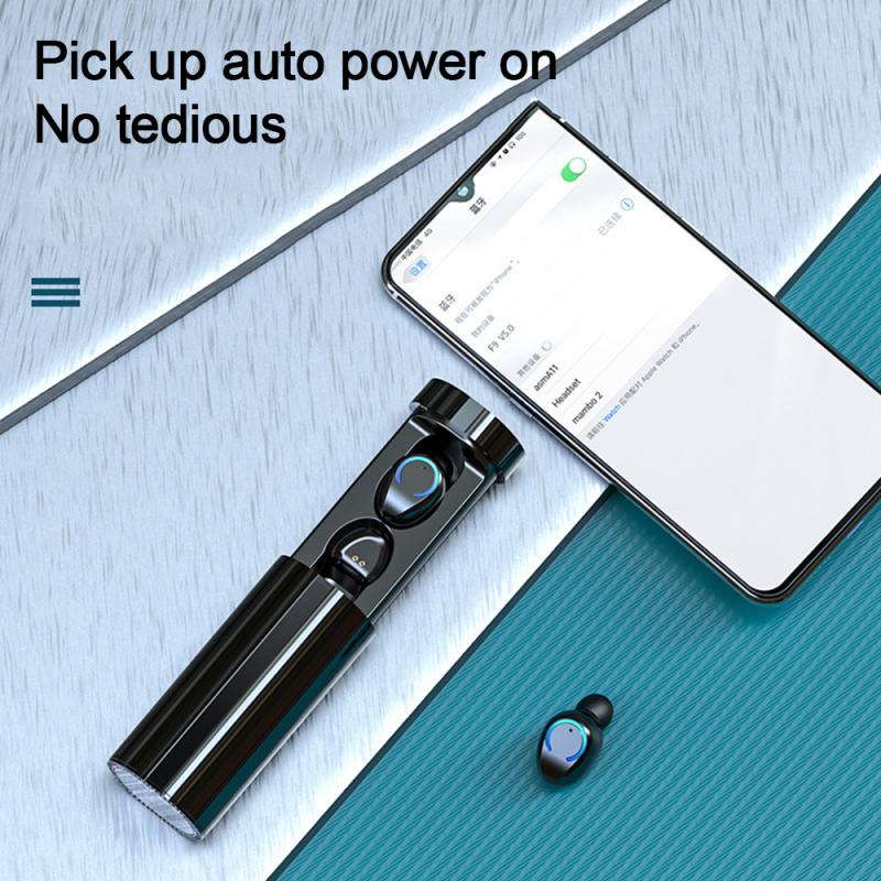 Black cylindrical charging case with two wireless earbuds, next to a smartphone displaying Bluetooth settings.