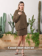 A woman wearing a brown knit sweater and matching short skirt, standing in front of cacti and greenery.