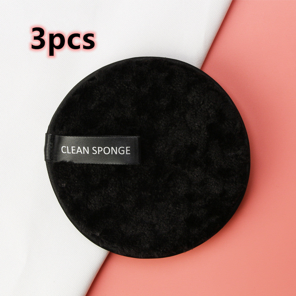 Set of 3 round, plush black makeup sponges with "CLEAN SPONGE" ribbon handle, on a pink and white background.
