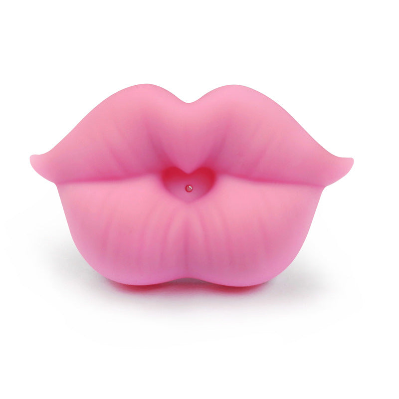 Pink silicone baby pacifier shaped like puckered lips with a small heart-shaped center, set against a white background.