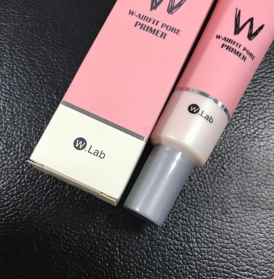 W.Lab W-Airfit Pore Primer box and tube. Pink and white packaging with grey cap on a black textured surface.