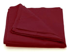 A folded, deep burgundy square fabric scarf with a smooth, matte finish isolated on a white background.