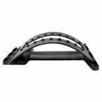 Black, arched plastic lumbar traction device with massage nodes for back pain relief, shown against a white background.