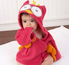 Baby wearing a soft, hot pink cotton hooded owl bathrobe with yellow accents and large eyes.