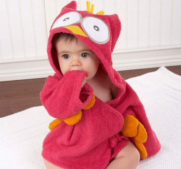 Baby wearing a soft, hot pink cotton hooded owl bathrobe with yellow accents and large eyes.