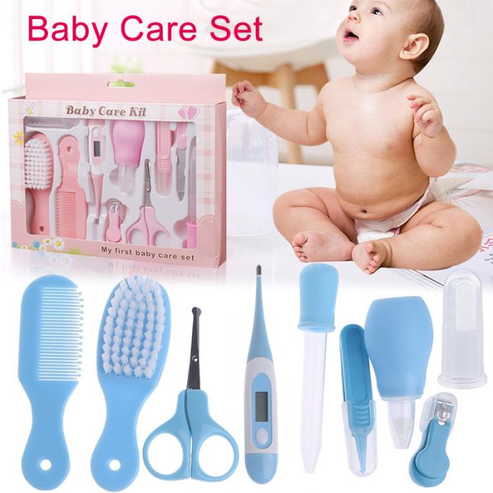 Pink baby care kit box and blue grooming tools: comb, brush, scissors, thermometer, dropper, and nail clipper.