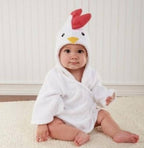 Baby wearing a white hooded cotton bathrobe with a cute chicken face, red crest, and yellow beak.