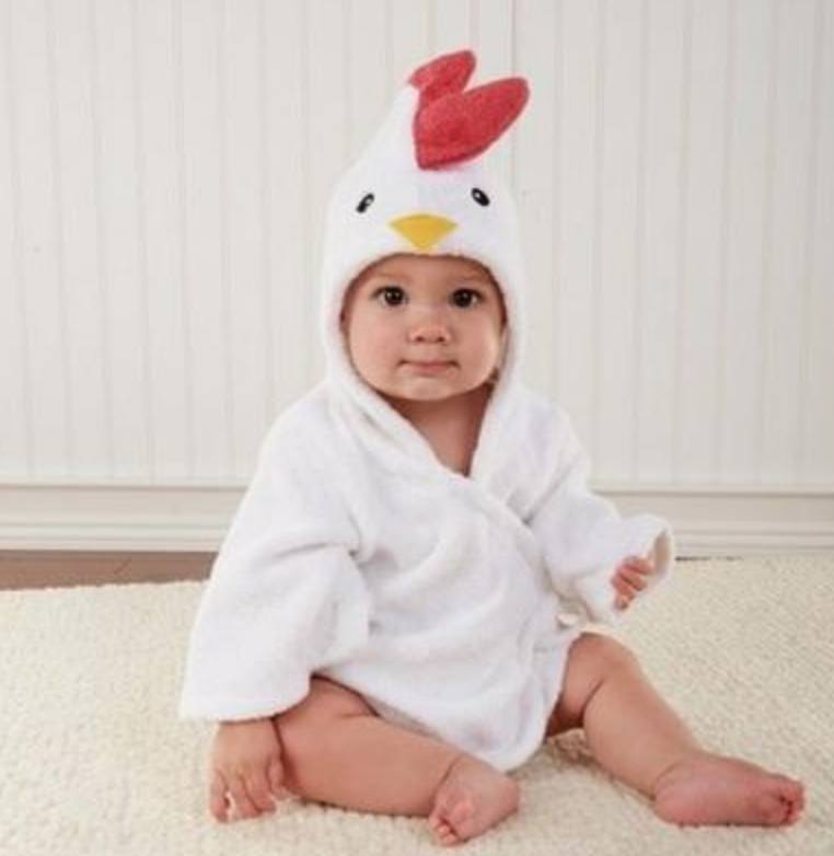 Baby wearing a white hooded cotton bathrobe with a cute chicken face, red crest, and yellow beak.