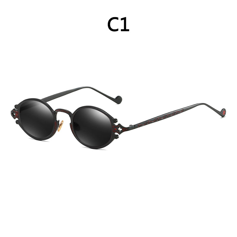 Retro steampunk sunglasses with round black lenses, ornate engraved metal temples, and a detailed frame design.