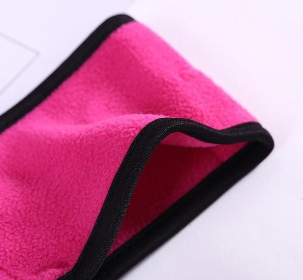 Bright pink fleece fitness headband with black trim, designed for Bluetooth audio integration during exercise.