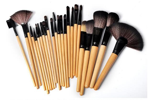 Set of 24 professional makeup brushes with light wood handles, black ferrules, and soft brown synthetic bristles.