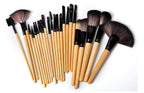 Set of 24 professional makeup brushes with light wood handles, black ferrules, and soft brown synthetic bristles.