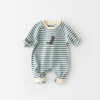 Long-sleeve baby jumpsuit in teal and white stripes with a small dinosaur embroidery and cream ribbed trim.