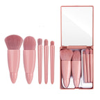 Five-piece pink makeup brush set with soft bristles, ergonomic handles, and a mirrored travel case.