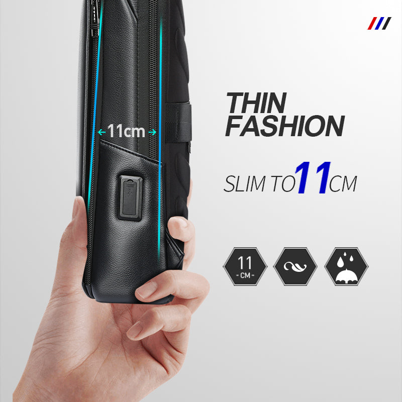 A hand holds a slim black leather backpack with a built-in USB charging port and an 11cm profile width.