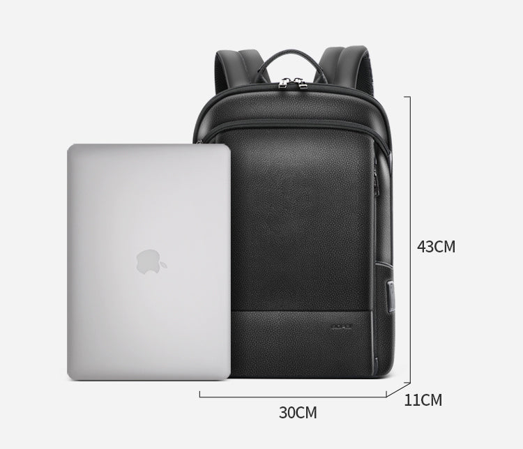 Black leather backpack with a silver laptop, USB port, and 43x30x11cm dimensions indicated.
