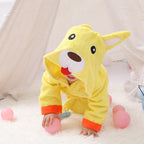 Yellow cotton baby bathrobe with a hooded cartoon dog face, featuring orange cuffs, worn by a child on a white rug.