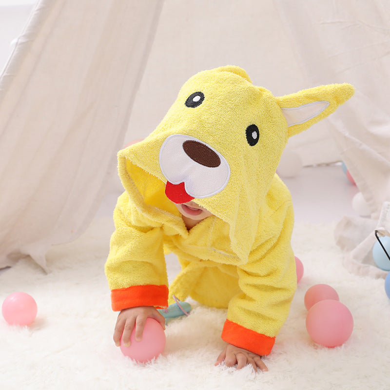 Yellow cotton baby bathrobe with a hooded cartoon dog face, featuring orange cuffs, worn by a child on a white rug.