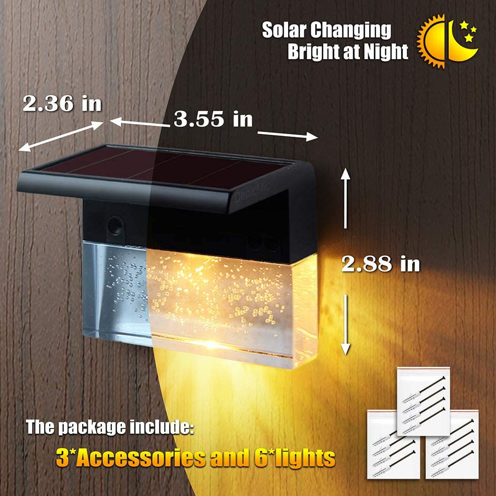 Black solar fence light with clear bubble-effect glass, emitting a warm glow. Includes dimensions and mounting hardware.