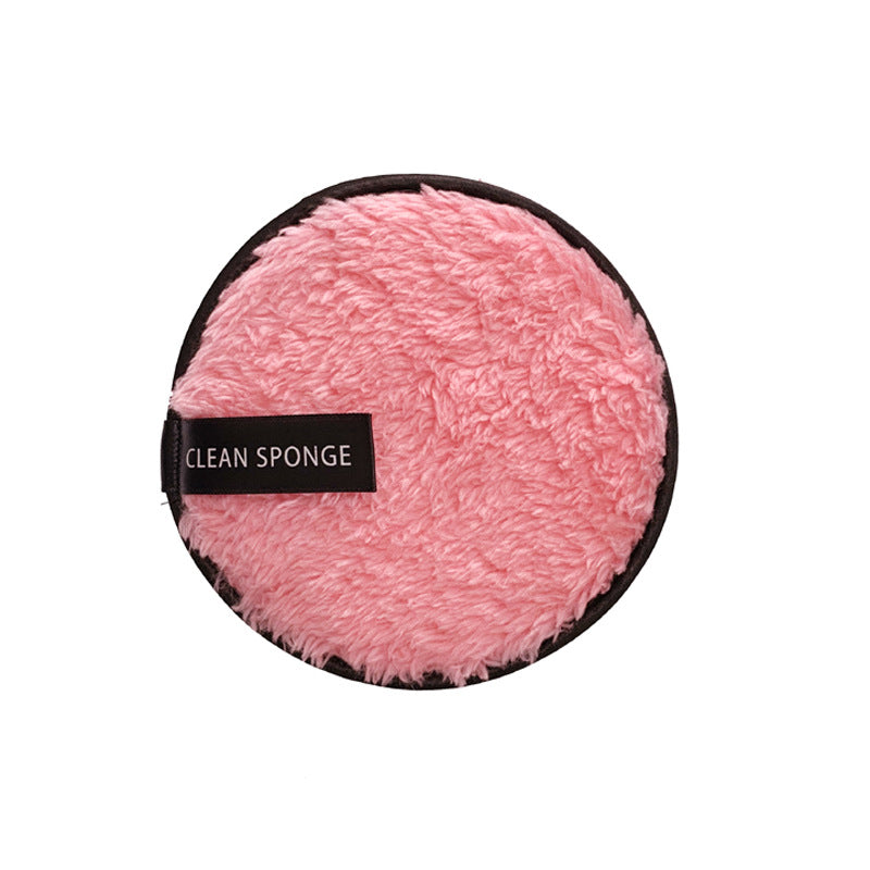 Round, fuzzy pink makeup puff with a black "CLEAN SPONGE" label and black trim against a white background.