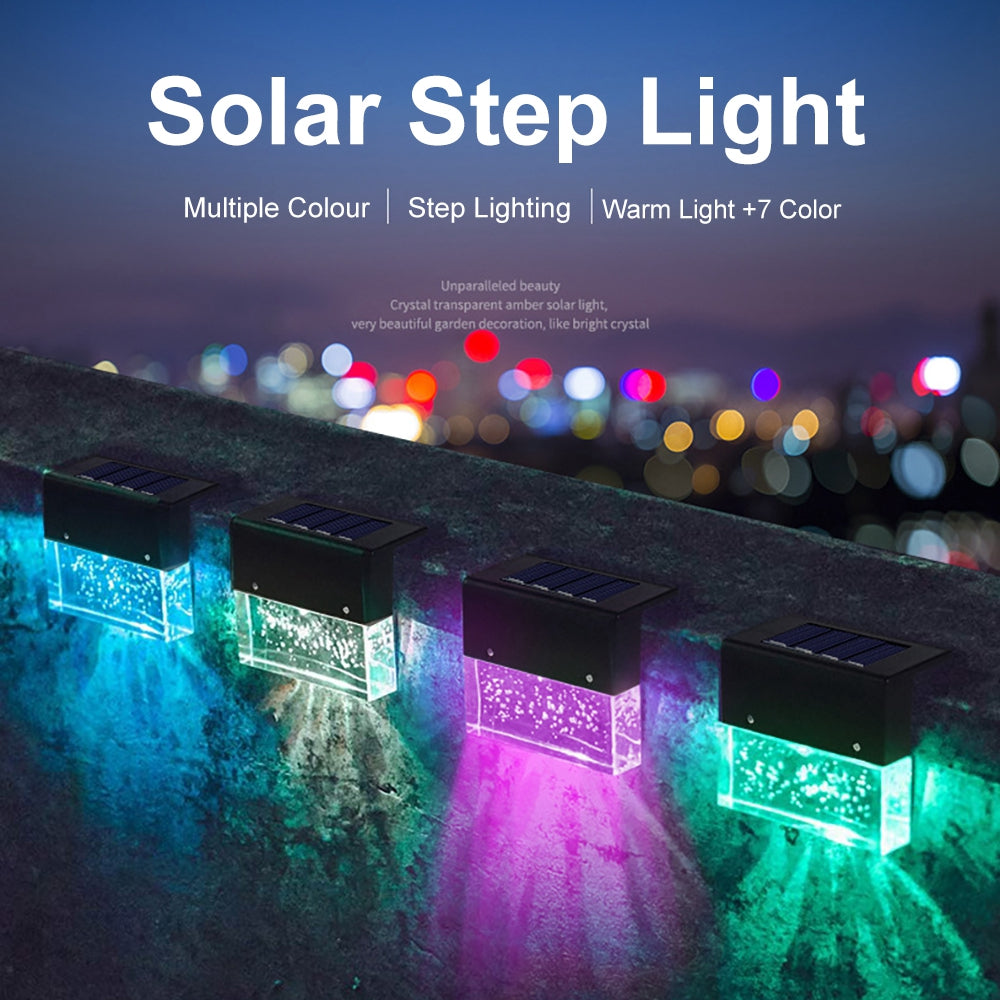 Four waterproof RGB LED solar step lights with bubble-textured crystal-look lenses, displaying various vibrant colors.