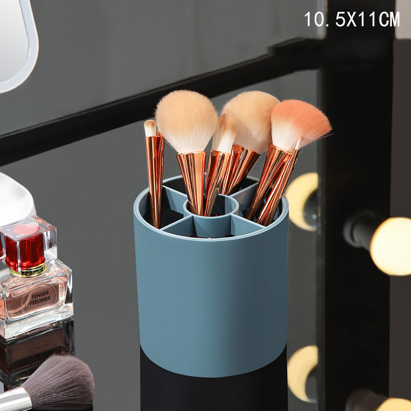 Blue cylindrical makeup brush holder with 5 internal compartments, holding assorted brushes with copper handles.