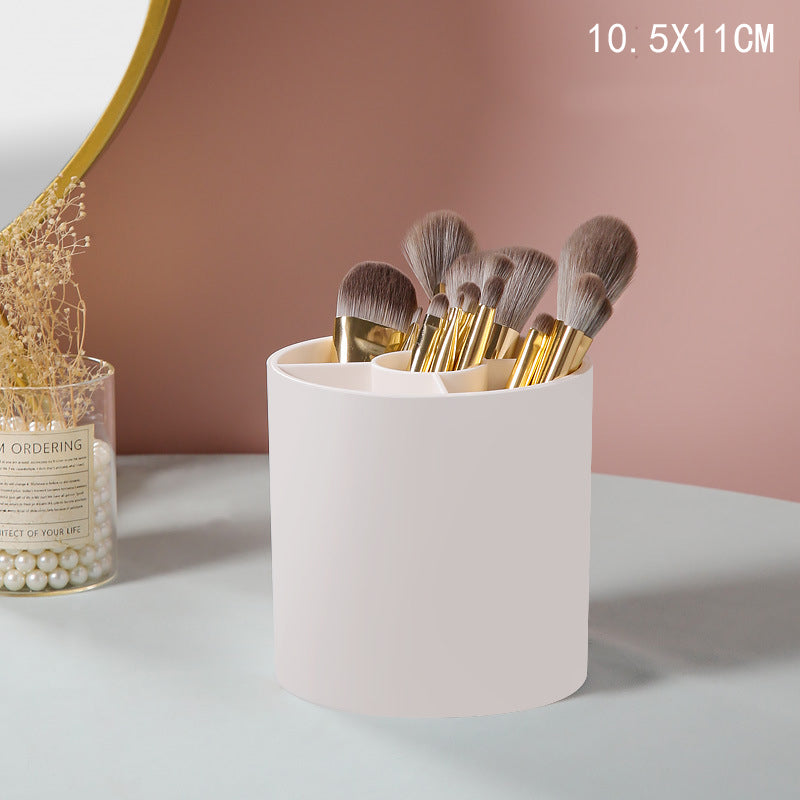White cylindrical plastic makeup brush organizer with multiple interior compartments, holding various makeup brushes.