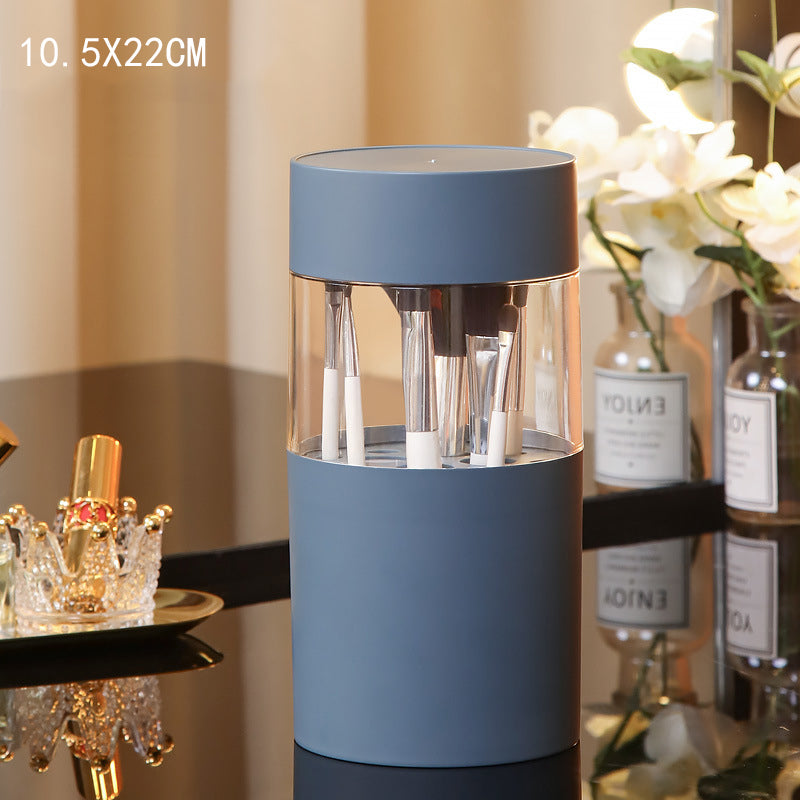 Dusty blue cylindrical makeup brush holder with a clear center section, measuring 10.5x22cm. Holds various brushes.