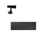 Black sit-up bar with foam-padded feet and a suction cup base, shown with a black yoga mat featuring alignment lines.