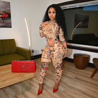 Woman wearing a slim-fit, tattoo-print long-sleeve sports jumpsuit with a front zipper, paired with red heels.
