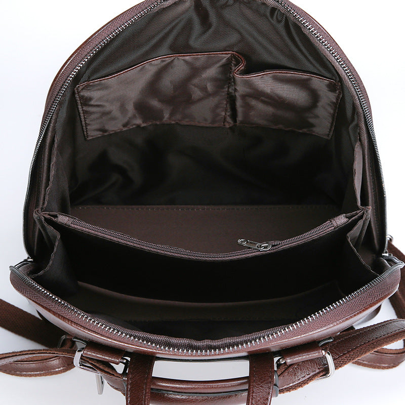 Interior of a brown soft leather backpack featuring zippered compartments and fabric organizer pockets.