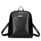 Black minimalist leather backpack with a front pocket, top handle, double-zipper closure, and adjustable straps.