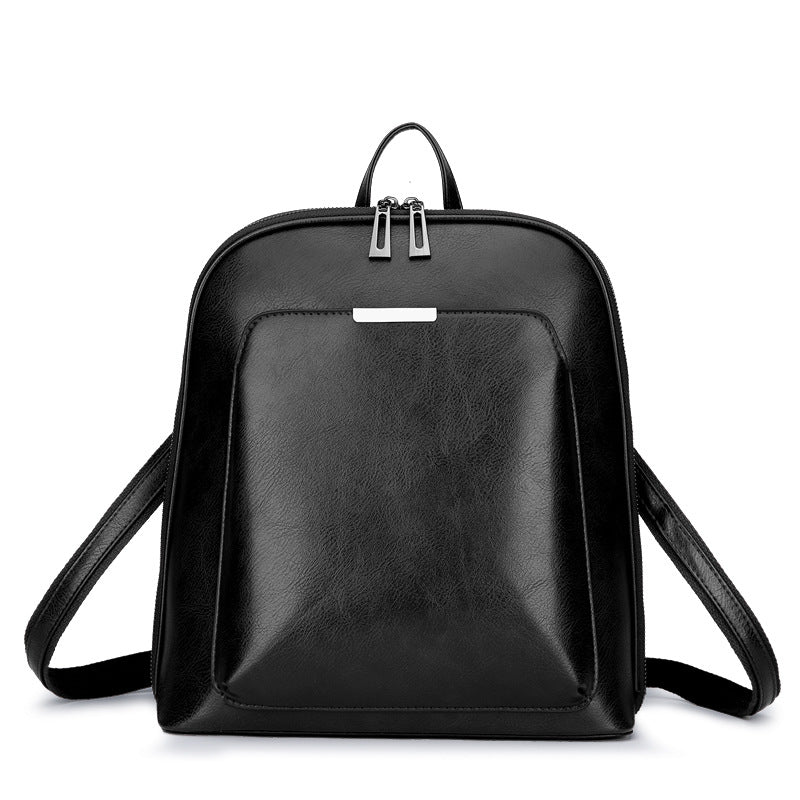 Black minimalist leather backpack with a front pocket, top handle, double-zipper closure, and adjustable straps.