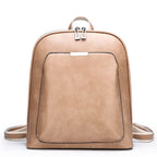 Tan faux leather women’s backpack with a front pocket, silver zippers, and adjustable canvas shoulder straps.