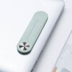 Mint green aluminum alloy side screen bracket attached to a silver laptop, featuring a metallic circular hinge.
