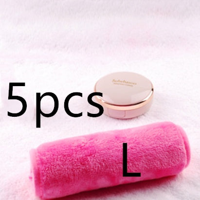A pink, plush microfiber makeup remover towel next to a Sulwhasoo compact on a soft, white textured background.