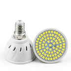 White plastic LED bulb with a screw base and a circular array of yellow LED chips on a flat face. Isolated on white.