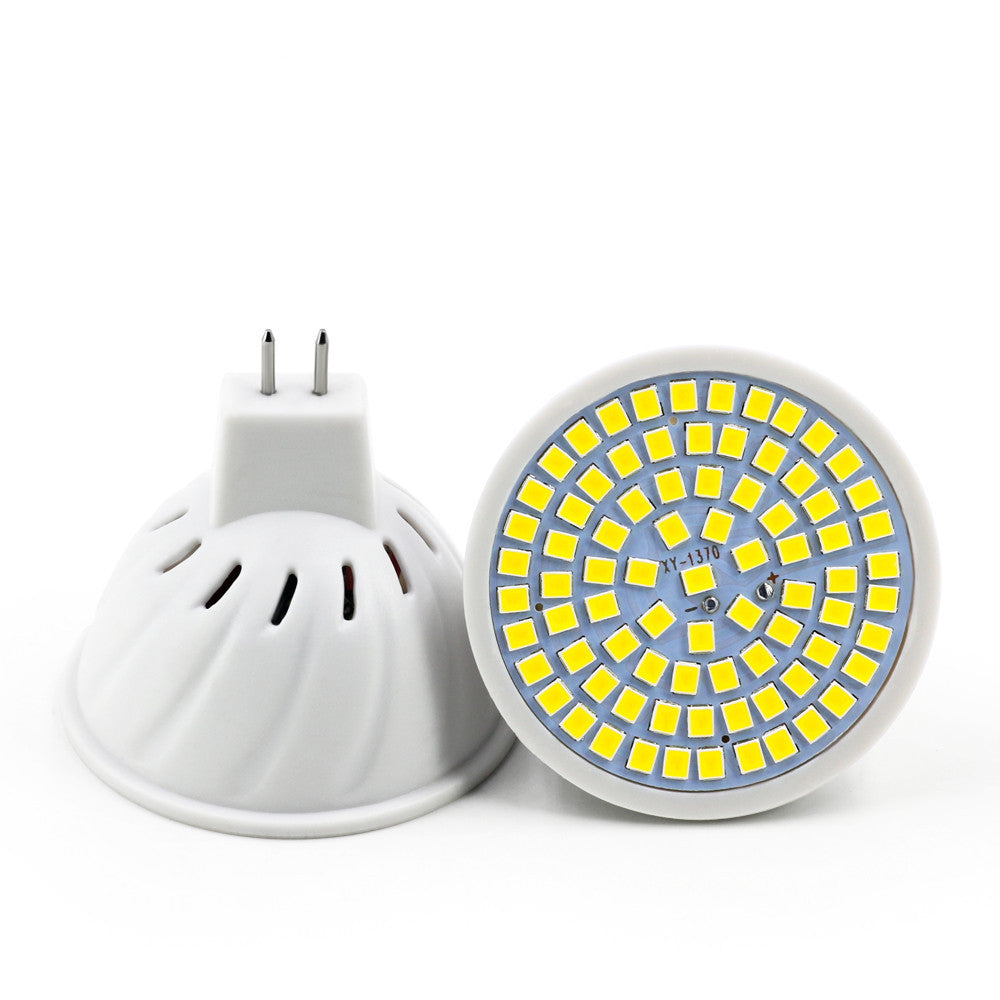 White plastic LED lamp cup with a circular array of yellow light-emitting diodes and a two-pin connector base.