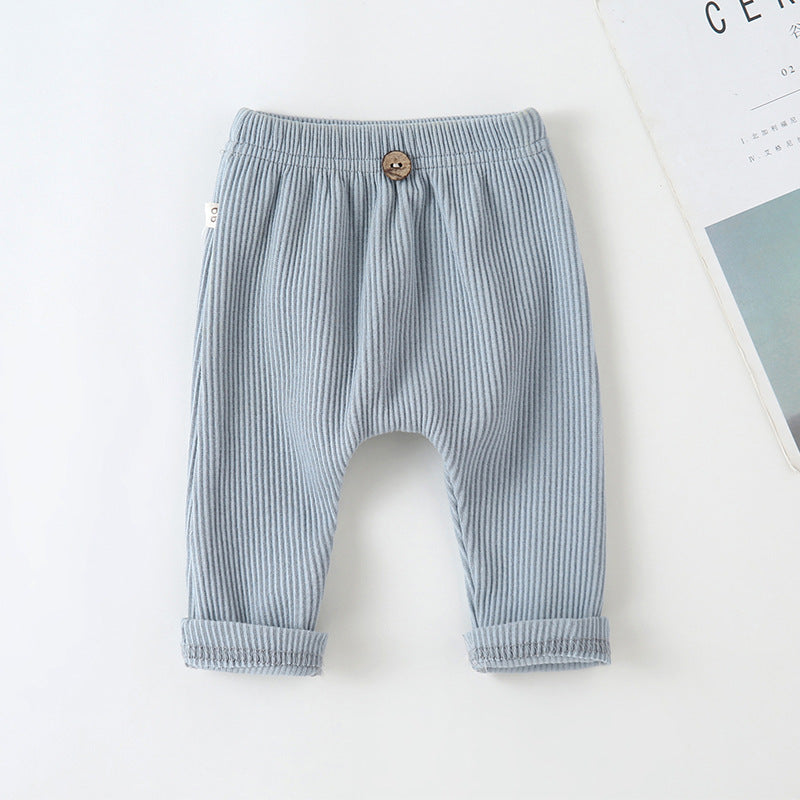 Light blue ribbed baby leggings with an elastic waist, decorative wooden button, and cuffed ankles.